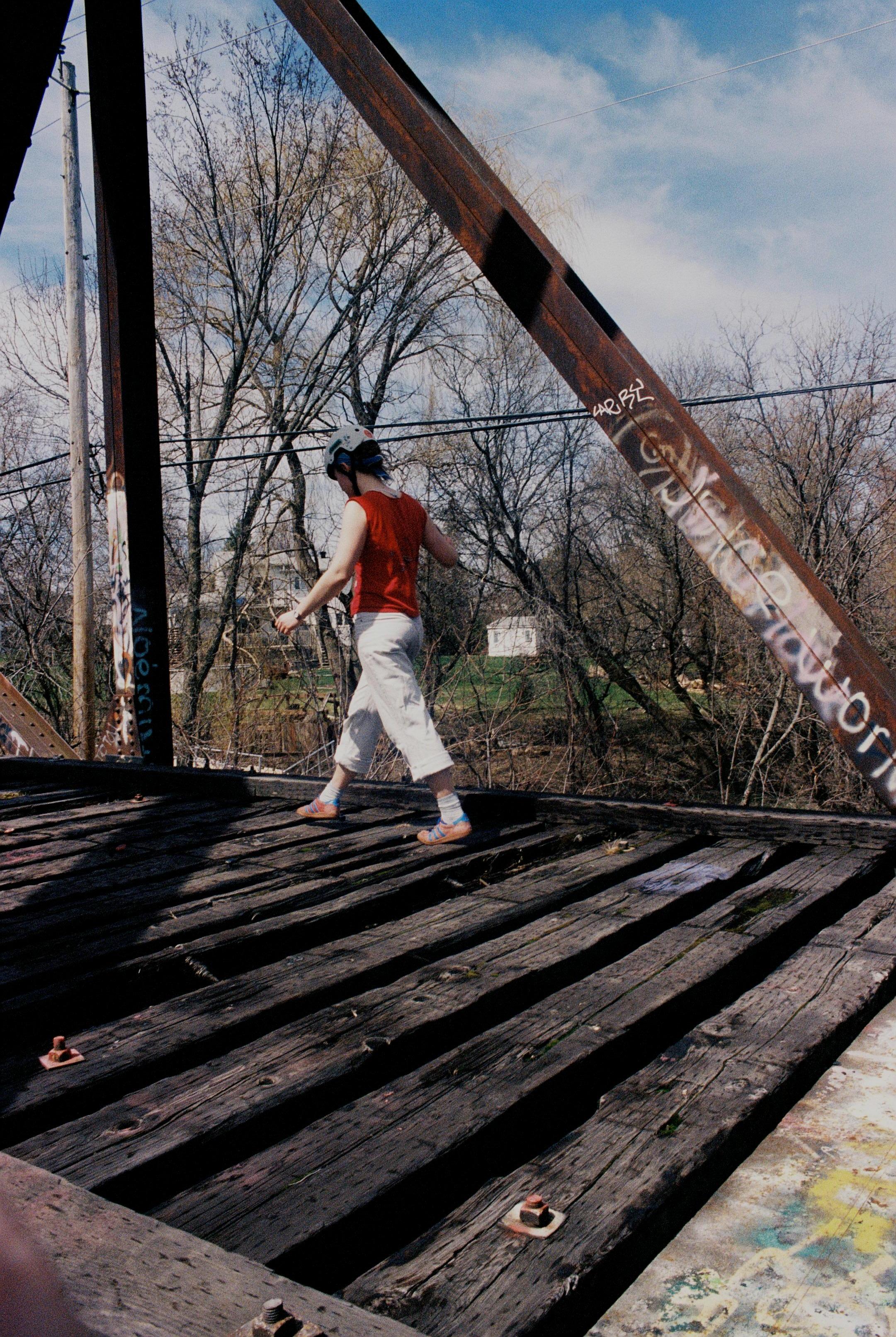 Young woman on railroad bridge