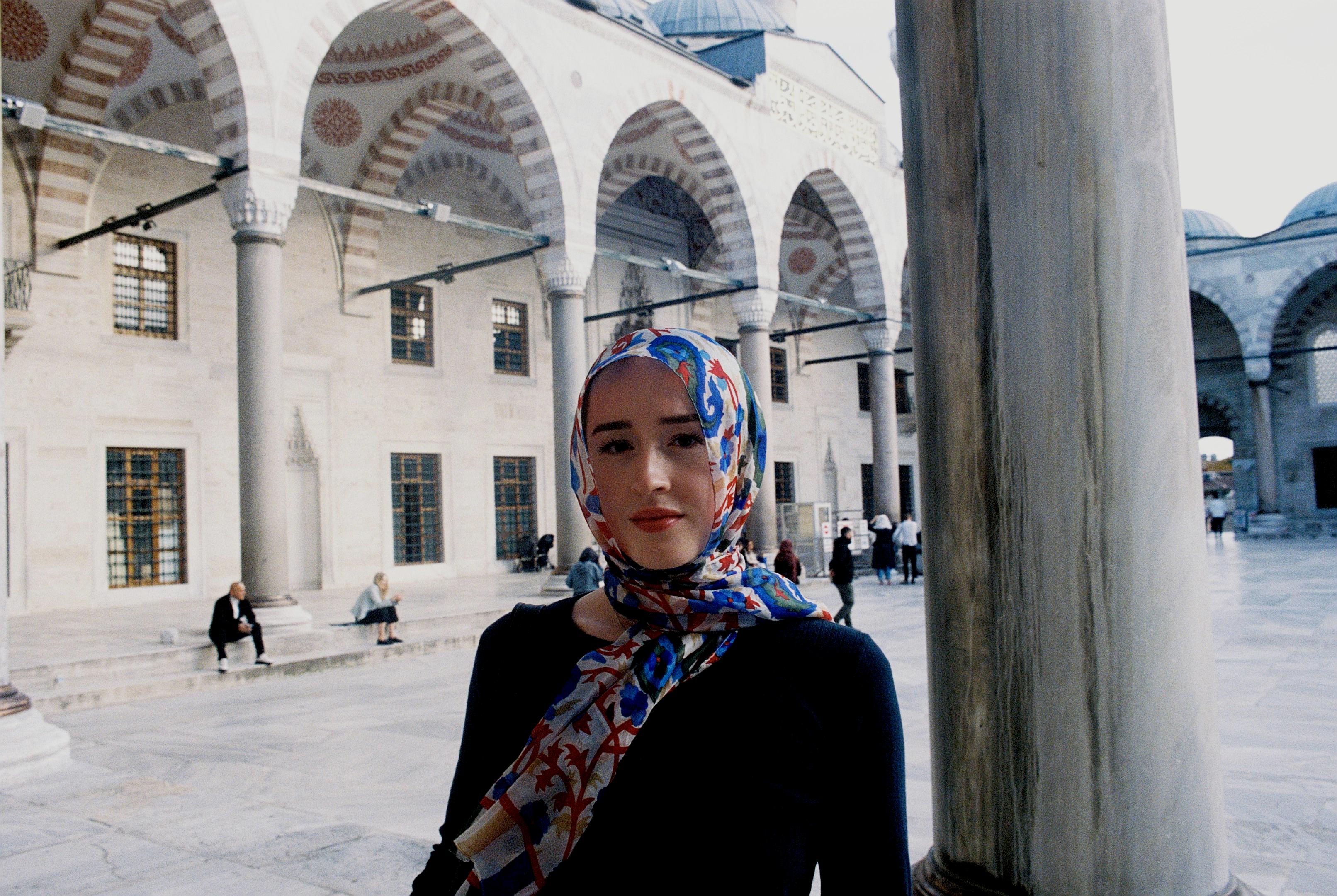 Young man veiled in Sultan Ahmen Mosque courtyard