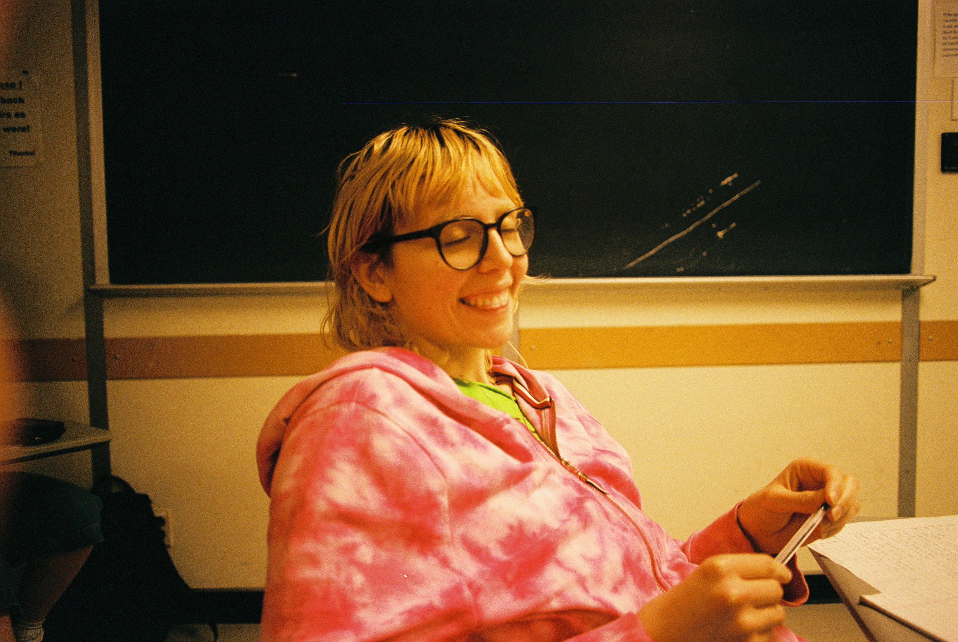 Young woman in a classroom smiles