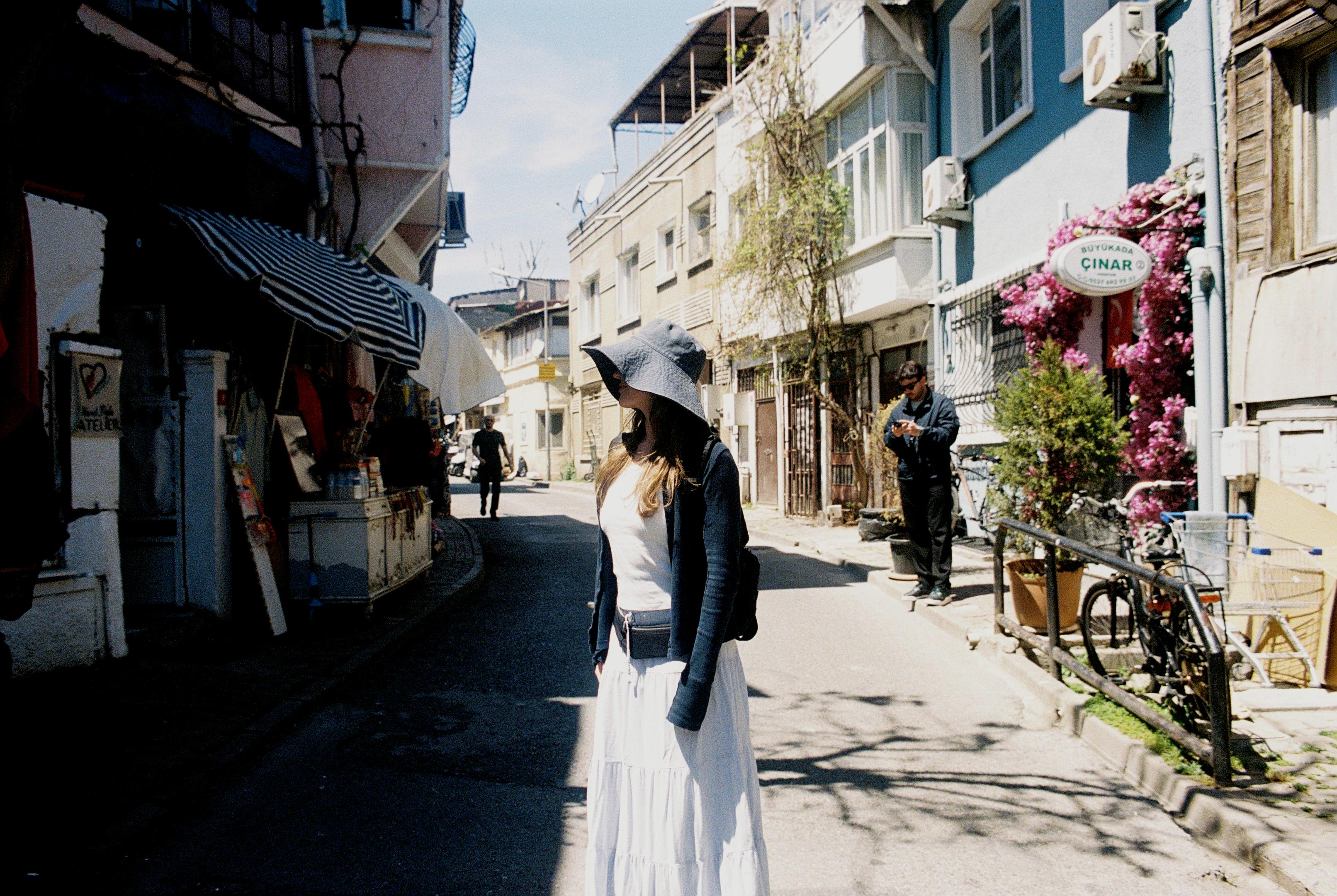 Young woman in market street in Istanbul turns away from the sun