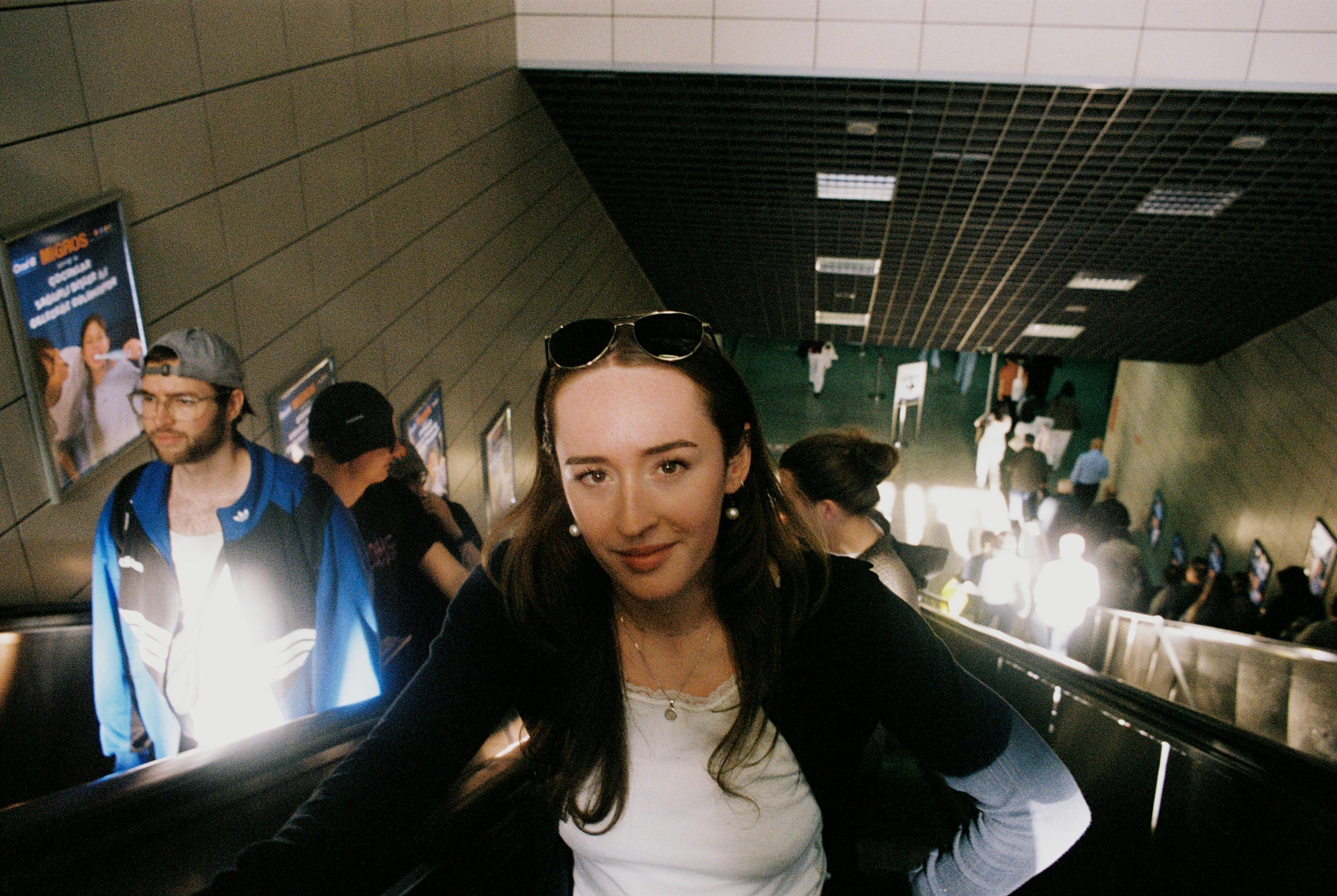 Young woman smiling while on escalator
